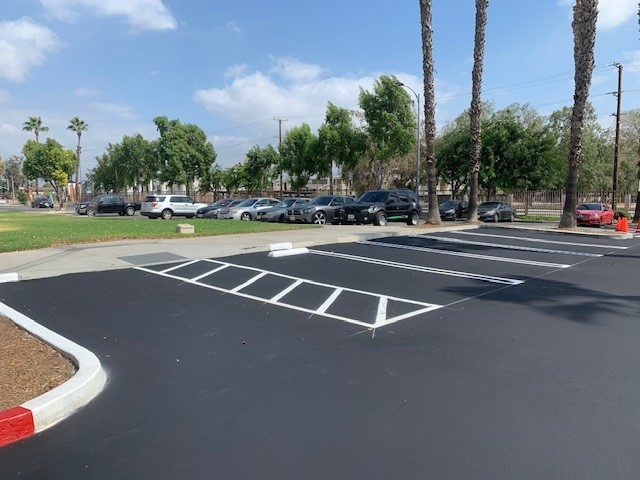 Parking lot with new sealcoating and ADA striping
