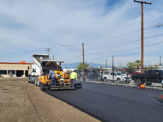 Paving crew laying new parking lot.