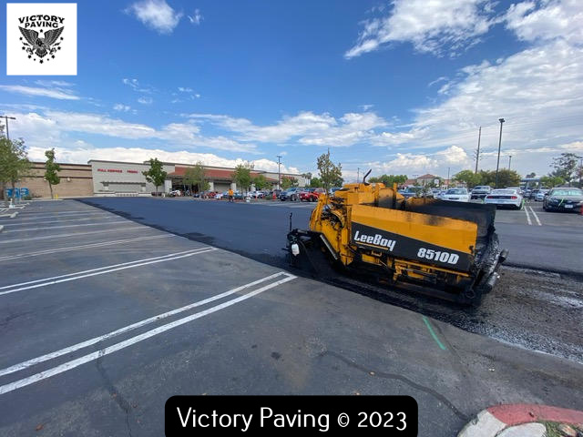 image of a paver laying asphalt in parking lot