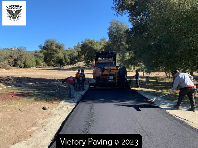 long driveway being paved with aspahlt